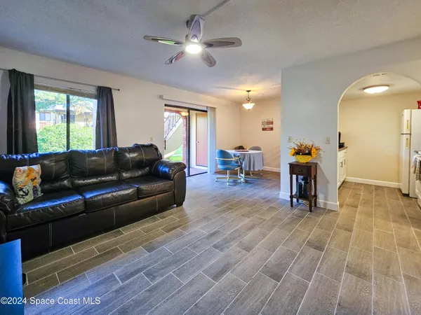 a dining room with furniture and wooden floor