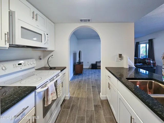 a kitchen with a table chairs and a stove