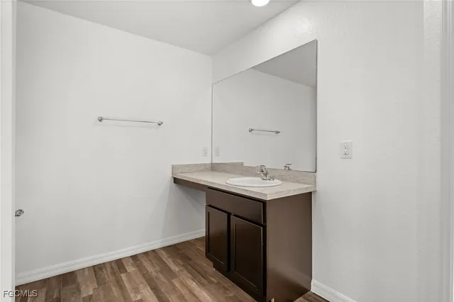 a utility room with a sink and vanity