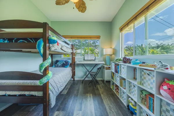 a bedroom with furniture a rug toys and a window