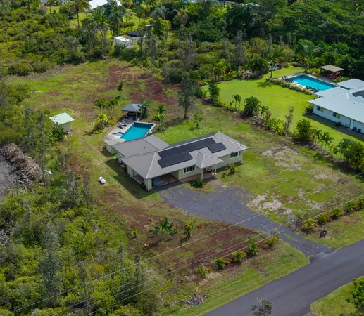 an aerial view of a house with a yard