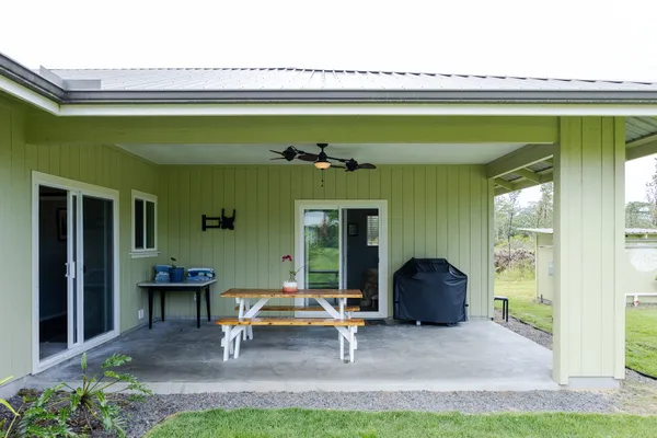 a front view of a house with a garden and a chair