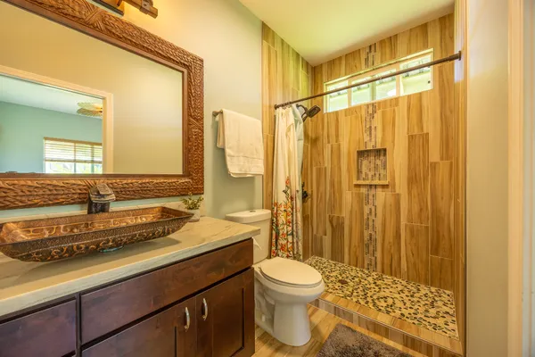 a bathroom with a sink a toilet and shower