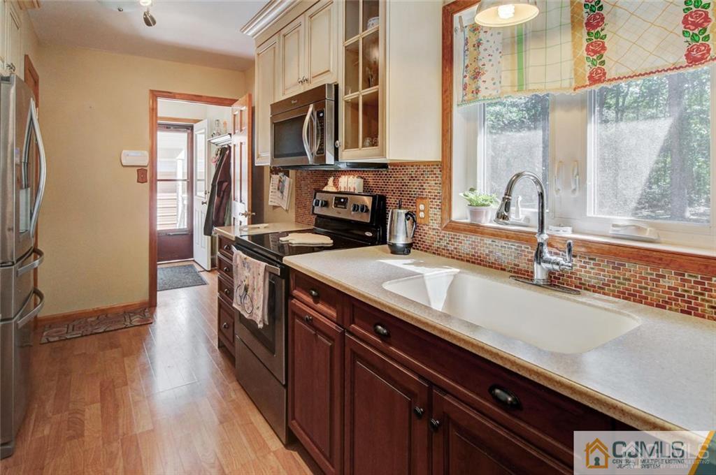 501 Pinehurst Road Cream Ridge, NJ 08514 - Photo 14 of 36 a kitchen with stainless steel appliances a sink and a stove