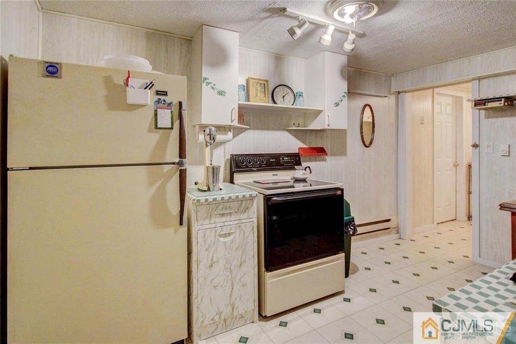 501 Pinehurst Road Cream Ridge, NJ 08514 - Photo 17 of 36 a kitchen with a refrigerator and a stove