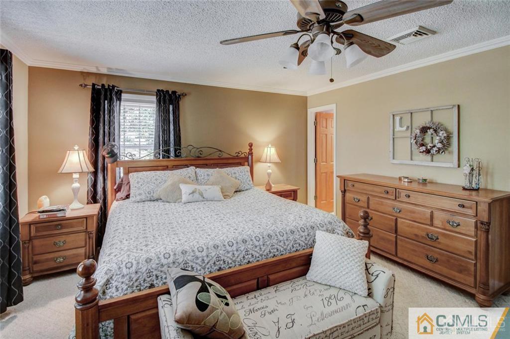 501 Pinehurst Road Cream Ridge, NJ 08514 - Photo 20 of 36 a bedroom with a bed and a dresser