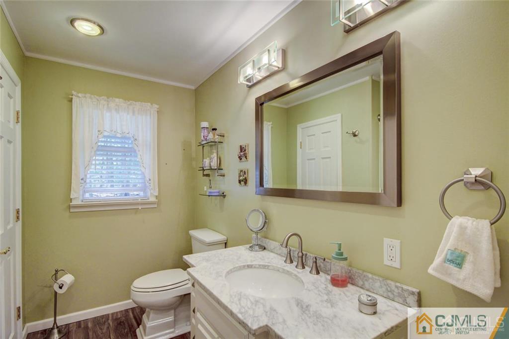 501 Pinehurst Road Cream Ridge, NJ 08514 - Photo 21 of 36 a bathroom with a granite countertop sink vanity mirror and toilet
