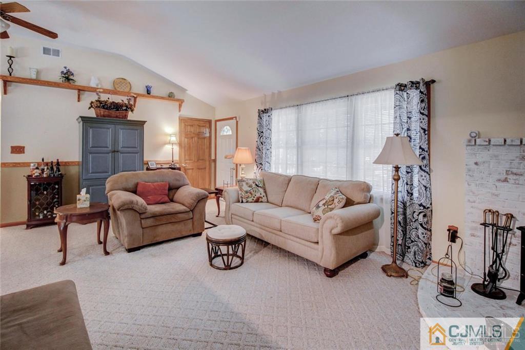 501 Pinehurst Road Cream Ridge, NJ 08514 - Photo 5 of 36 a living room with furniture and a flat screen tv