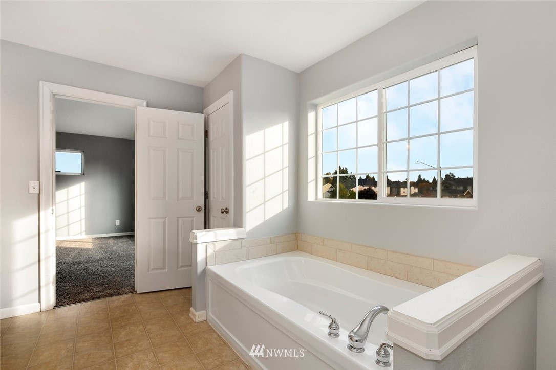 16410 Northeast 12th Court Ridgefield, WA 98642 - Photo 16 of 25 a bathroom with a tub and a window