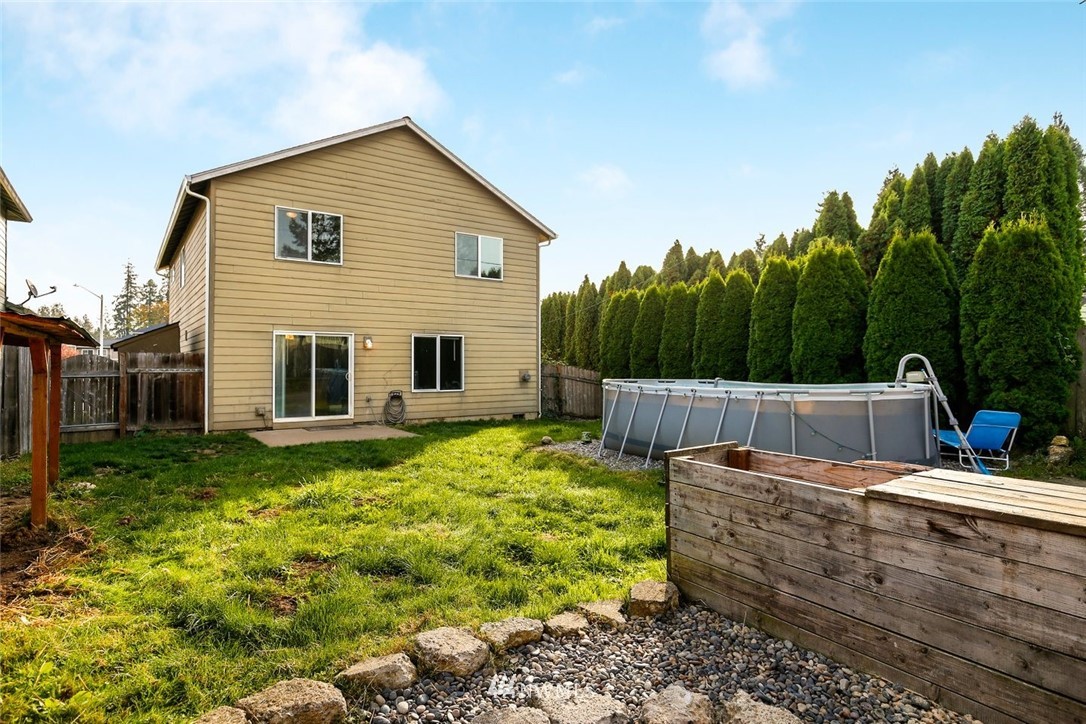 16410 Northeast 12th Court Ridgefield, WA 98642 - Photo 24 of 25 a view of a backyard with couches plants and large tree