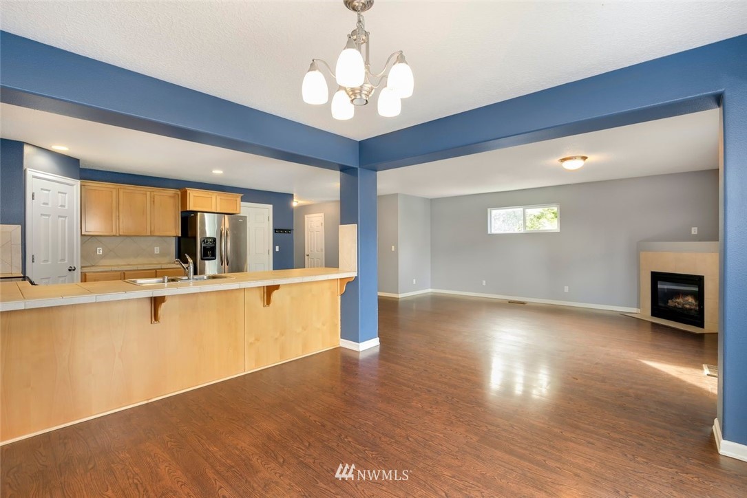16410 Northeast 12th Court Ridgefield, WA 98642 - Photo 5 of 25 a view of a kitchen with a sink and a large window