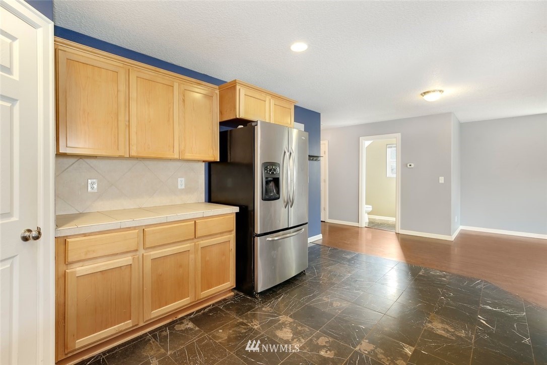 16410 Northeast 12th Court Ridgefield, WA 98642 - Photo 10 of 25 a kitchen with stainless steel appliances granite countertop a refrigerator and a stove top oven