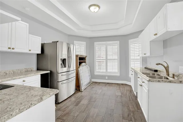 a kitchen with a refrigerator a stove top oven a sink and dishwasher