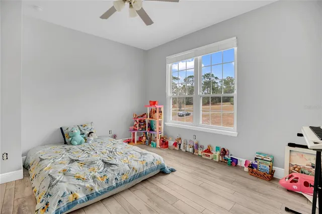 a bed sitting in a bedroom next to a window