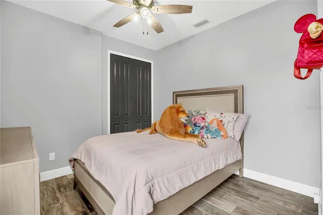 a bedroom with bed and a chandelier