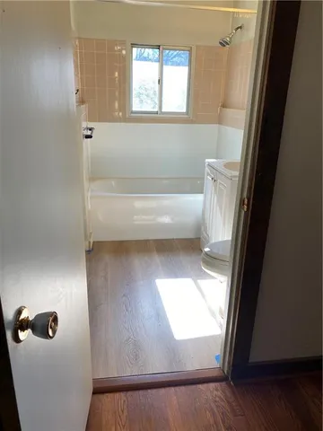 a bathroom with a window and a shower