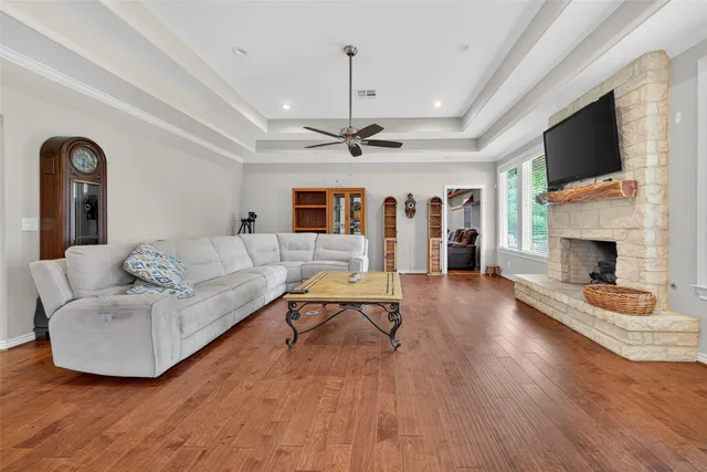 a living room with furniture and a chandelier