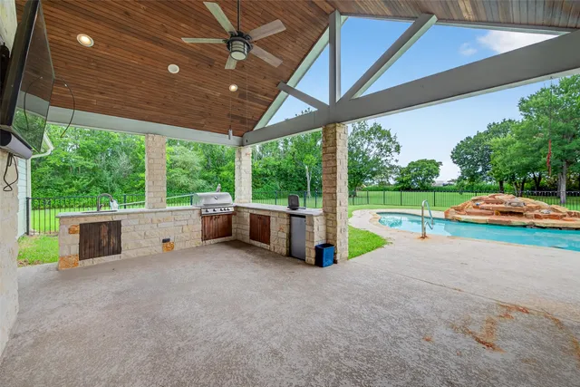 a view of a porch with furniture and a yard