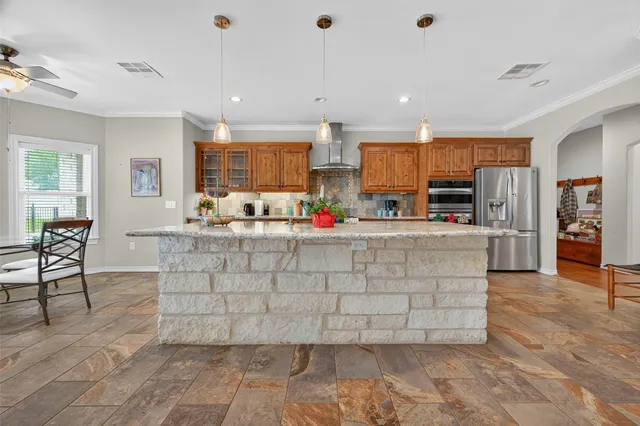 a kitchen with stainless steel appliances granite countertop a stove and a sink