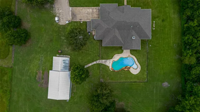 an aerial view of a house with a yard