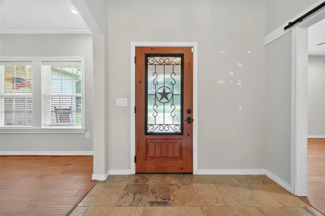 a view of livingroom with window chandelier and wooden floor