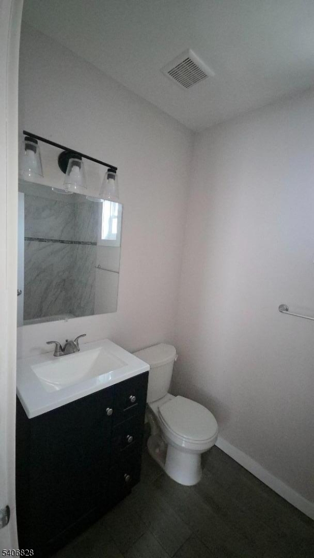 10 Shaw Avenue, Unit 2 Newark, NJ 07112 - Photo 11 of 15 a bathroom with a sink vanity mirror and toilet