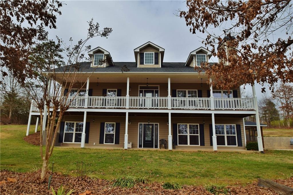 9223 Callus Mill Road Lula, GA 30554 - Photo 1 of 1 a front view of a building with a garden