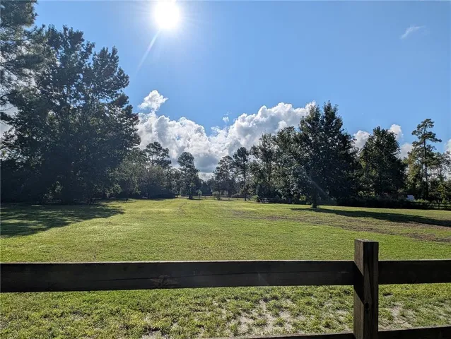 a view of a large pool with a yard