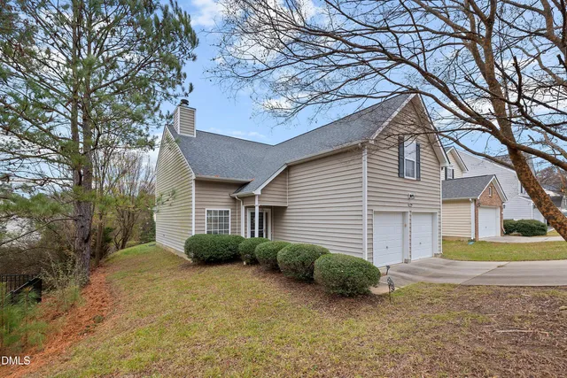 a view of a house with a yard and garage
