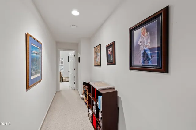 a view of a hallway with paintings on the wall