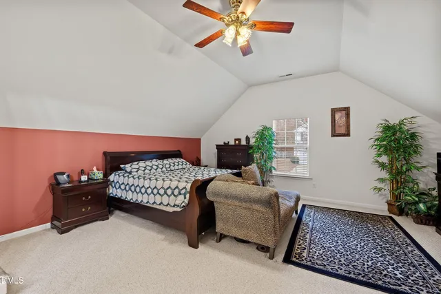 a bedroom with furniture and a potted plant