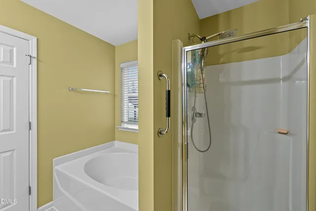 a bathroom with a shower and a bath tub