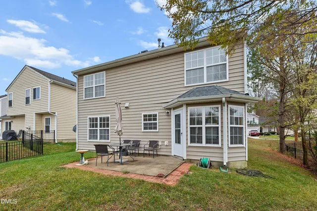 a view of a house with a yard and sitting area