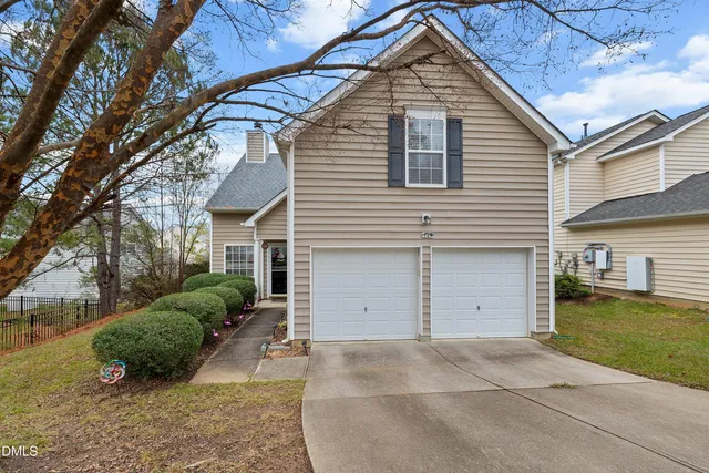 a view of a house with a yard and garage