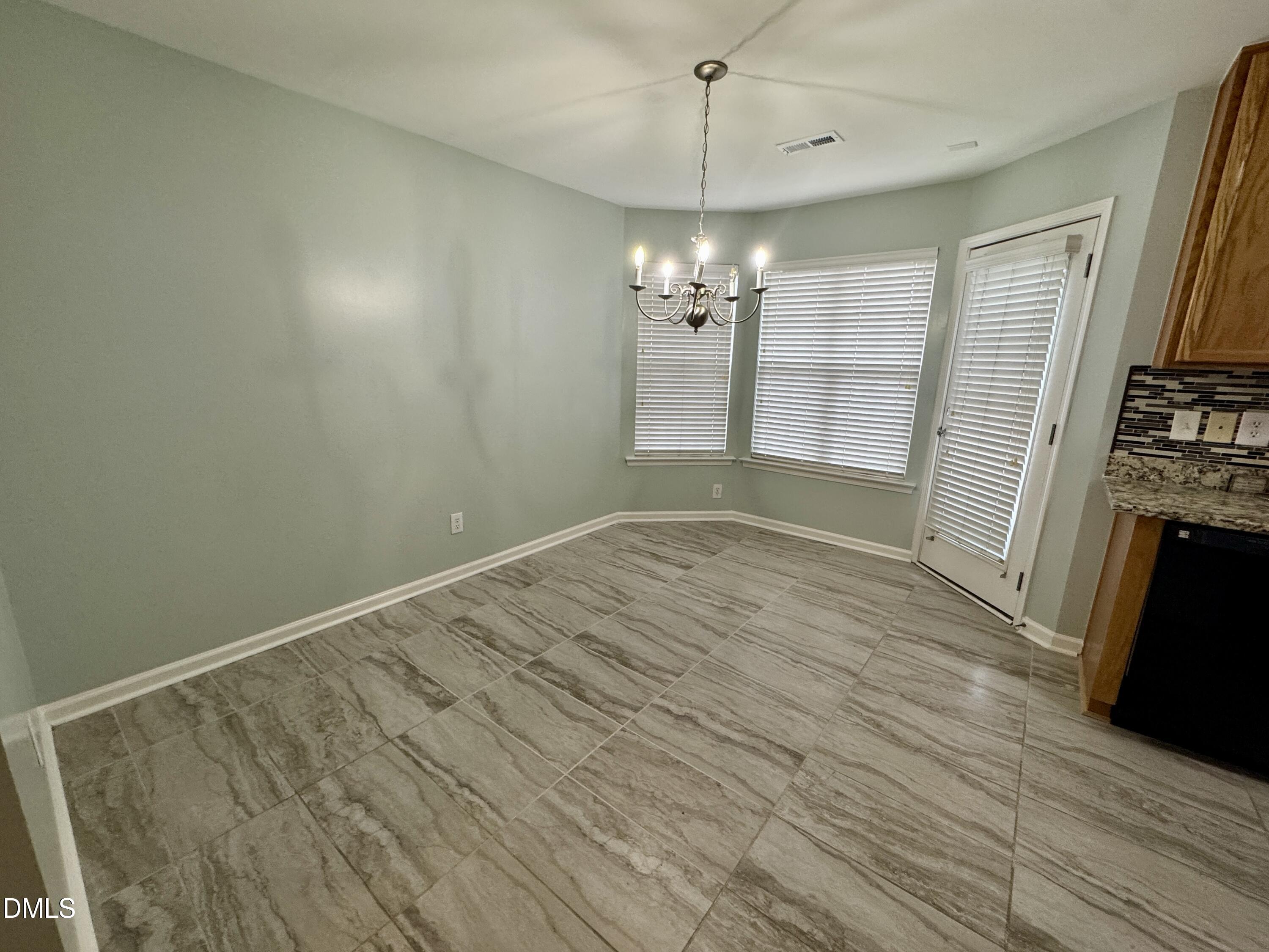 125 River Pearl Street Raleigh, NC 27603 - Photo 5 of 34 an empty room with wooden floor and window