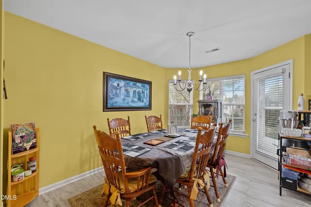 a view of a dining room with furniture and chandelier