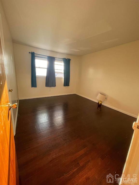666 Chestnut Place, Unit 2F Secaucus, NJ 07094 - Photo 2 of 4 an empty room with wooden floor and windows