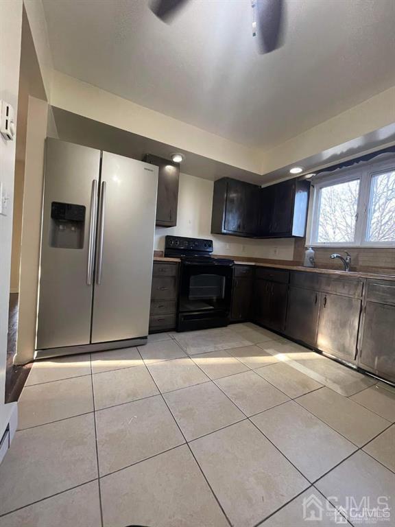 666 Chestnut Place, Unit 2F Secaucus, NJ 07094 - Photo 3 of 4 a kitchen with stainless steel appliances granite countertop a refrigerator and a sink