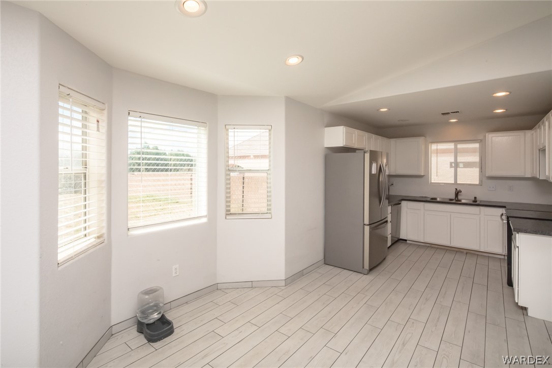 2080 Jamie Road Fort Mohave, AZ 86426 - Photo 12 of 29 a kitchen with a refrigerator and white cabinets