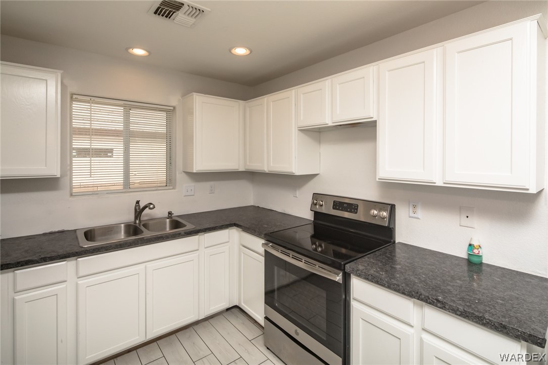 2080 Jamie Road Fort Mohave, AZ 86426 - Photo 14 of 29 a kitchen with granite countertop white cabinets and white appliances