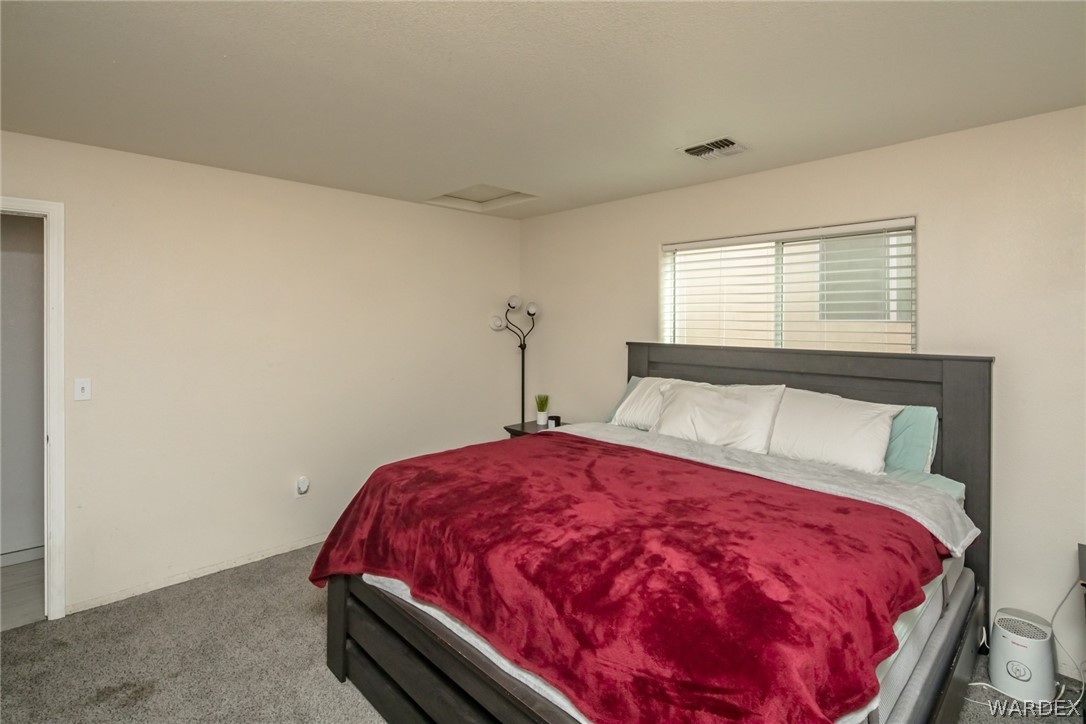 2080 Jamie Road Fort Mohave, AZ 86426 - Photo 18 of 29 a bed sitting in a bedroom next to a window