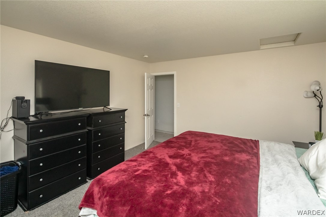 2080 Jamie Road Fort Mohave, AZ 86426 - Photo 19 of 29 a bedroom with a bed and a flat screen tv