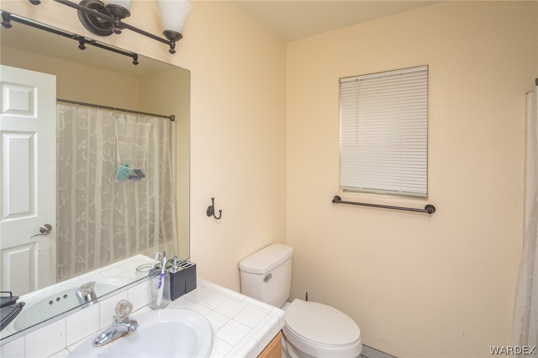 2080 Jamie Road Fort Mohave, AZ 86426 - Photo 23 of 29 a bathroom with a sink a toilet and shower