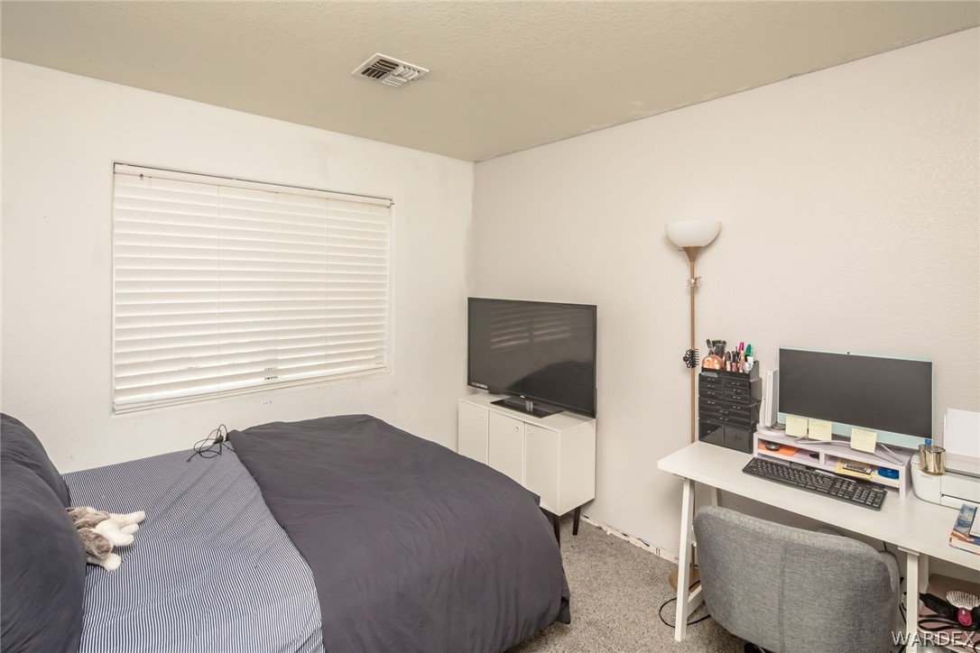 2080 Jamie Road Fort Mohave, AZ 86426 - Photo 24 of 29 a bedroom with a bed and a flat screen tv