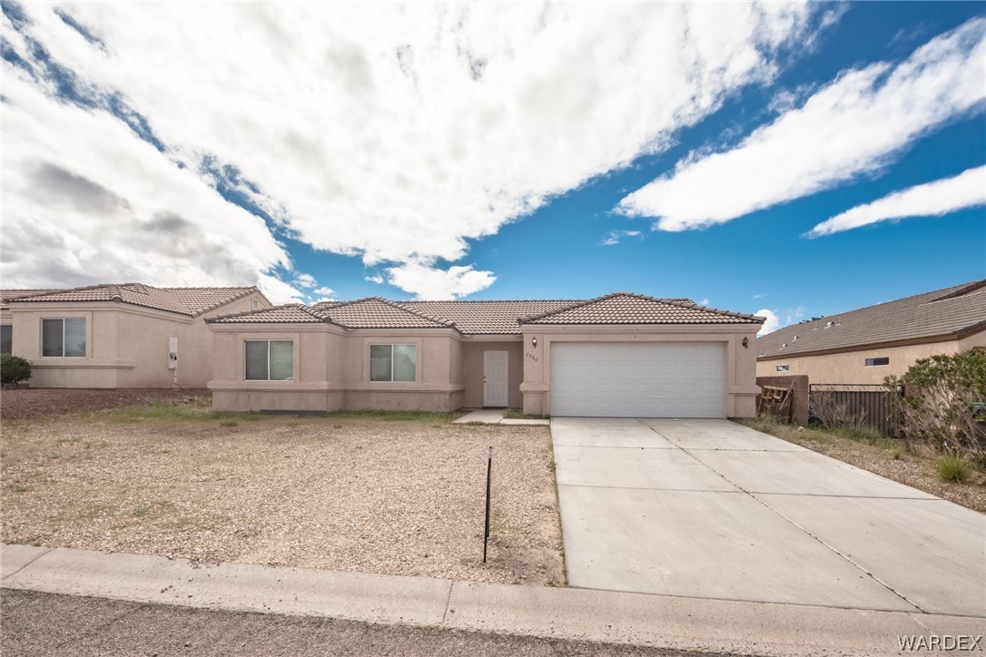 2080 Jamie Road Fort Mohave, AZ 86426 - Photo 3 of 29 a view of a house with a large tree and a big yard
