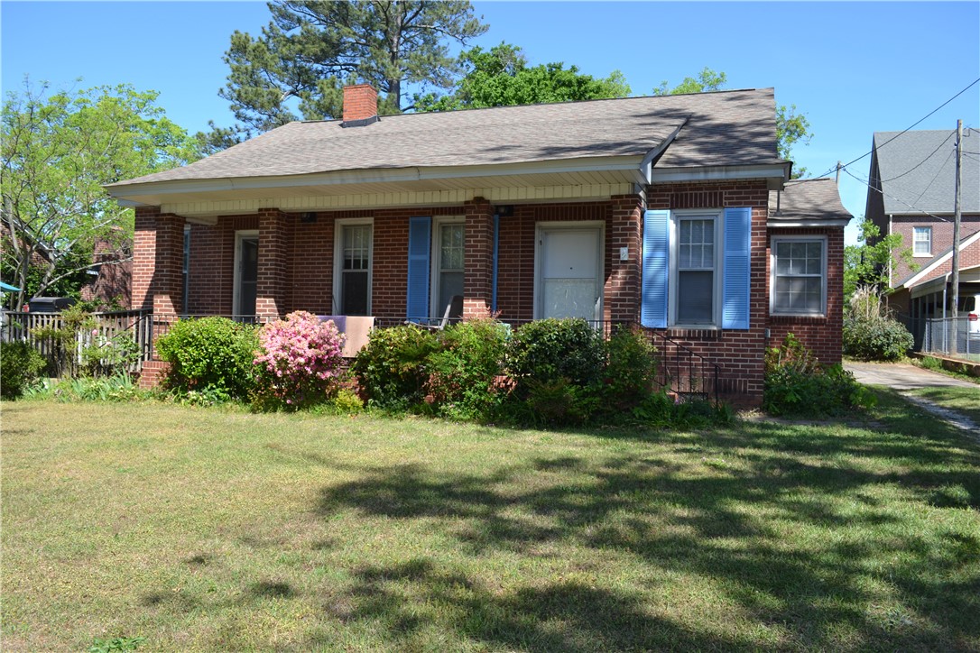 205 B East Broad Street Anderson, SC 29621 - Photo 1 of 27 This charming brick home features a welcoming covered porch, mature landscaping, and a well-maintained lawn.