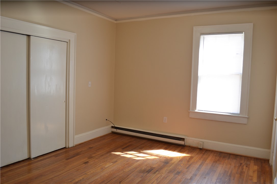205 B East Broad Street Anderson, SC 29621 - Photo 4 of 27 This sun-drenched bedroom offers a welcoming atmosphere and rich hardwood flooring, creating a cozy personal retreat.