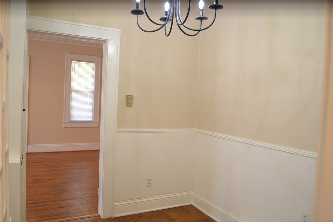 205 B East Broad Street Anderson, SC 29621 - Photo 5 of 27 This inviting space features a charming chandelier and classic wainscoting.