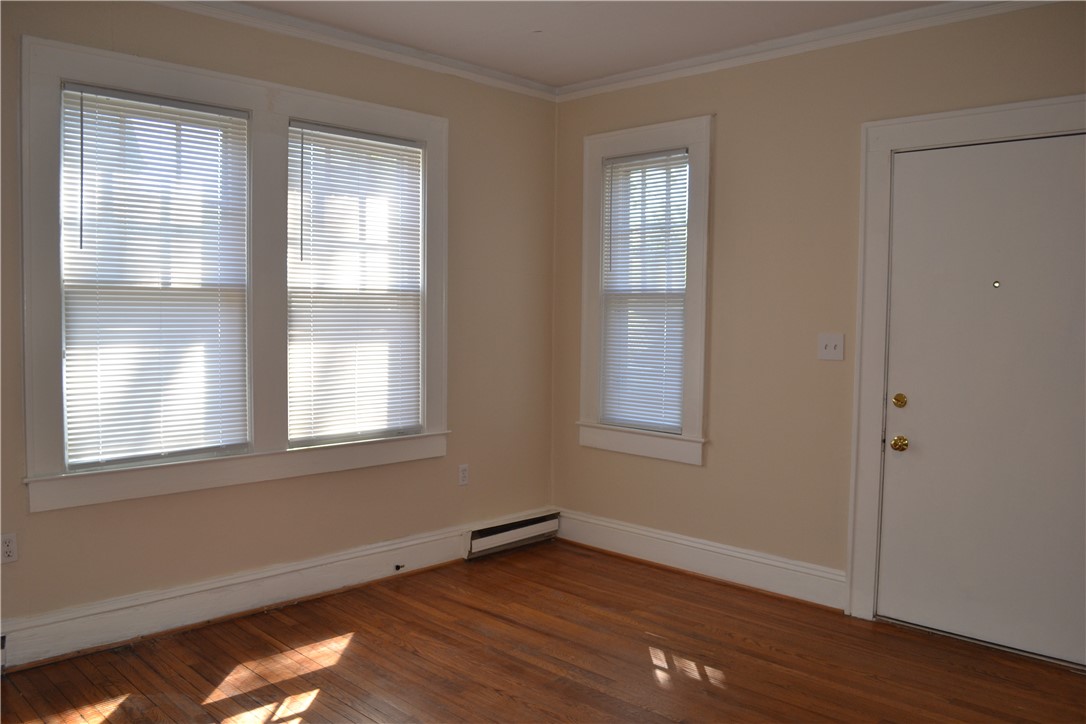 205 B East Broad Street Anderson, SC 29621 - Photo 6 of 27 Bright, airy room with gleaming hardwood floors, ample natural light, and classic crown molding.