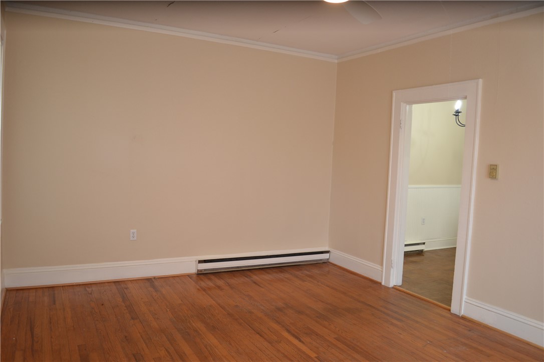 205 B East Broad Street Anderson, SC 29621 - Photo 7 of 27 This inviting space features classic hardwood flooring and a functional baseboard heating system.